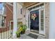 Inviting entrance features a black front door with sidelights, flanked by plants and a decorative mat at 214 Lions Gate Dr, Cary, NC 27518