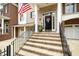 Charming entrance with brick steps and iron railing leading to the front door at 214 Lions Gate Dr, Cary, NC 27518