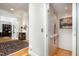 Bright hallway with hardwood floors, open doorways, and an elevator at 214 Lions Gate Dr, Cary, NC 27518