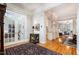 Elegant hallway with hardwood floors, glass French doors, and view into other living spaces at 214 Lions Gate Dr, Cary, NC 27518