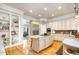 Bright kitchen featuring stainless steel appliances, granite counters, and light wood flooring at 214 Lions Gate Dr, Cary, NC 27518
