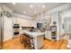 Open kitchen with an island, stainless steel appliances, and white cabinets at 214 Lions Gate Dr, Cary, NC 27518