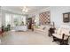 Relaxing living room featuring large window, sofa, and comfortable rocking chair at 214 Lions Gate Dr, Cary, NC 27518