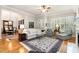 Well-lit living room featuring hardwood floors, neutral paint, and elegant furnishings at 214 Lions Gate Dr, Cary, NC 27518