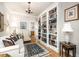 Elegant living room with custom bookcase, chandelier, and comfortable seating, perfect for relaxation and reading at 214 Lions Gate Dr, Cary, NC 27518