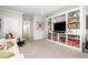 Cozy living room with neutral walls and flooring, built-in bookshelves and TV at 214 Lions Gate Dr, Cary, NC 27518
