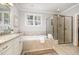 Luxurious main bathroom with soaking tub, glass shower, granite countertops, and elegant finishes throughout at 214 Lions Gate Dr, Cary, NC 27518