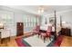 Bright main bedroom boasts a four-poster bed, natural light, and stylish decor; perfect for relaxation and comfort at 214 Lions Gate Dr, Cary, NC 27518