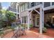 Cozy brick patio with outdoor seating, lush greenery, and a charming entrance to the home at 214 Lions Gate Dr, Cary, NC 27518