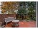 Relaxing brick patio featuring a bench, fire pit, and mature landscaping for serene outdoor living at 214 Lions Gate Dr, Cary, NC 27518