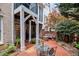 Serene brick patio with outdoor seating, mature landscaping, and easy access to the house at 214 Lions Gate Dr, Cary, NC 27518