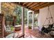 Charming covered patio with a swing, seating area, and a view of the beautifully landscaped garden at 214 Lions Gate Dr, Cary, NC 27518