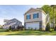 Two-story home with stone accents, a two-car garage, and beautiful landscaping at 2145 Monk Dr, Haw River, NC 27258