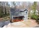 Aerial view of a charming two-story home with a inviting front porch and well-maintained landscaping at 218 Archdale Dr, Durham, NC 27707