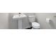 Powder room featuring a pedestal sink and toilet with dark vinyl floors at 218 Archdale Dr, Durham, NC 27707