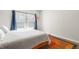 This bright bedroom features a window with blue drapes and a cozy rug at 218 Archdale Dr, Durham, NC 27707