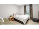 Cozy bedroom with a double bed, bedside table, and soft gray walls at 218 Archdale Dr, Durham, NC 27707