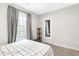 Bedroom featuring a view of the window and gray accent curtains at 218 Archdale Dr, Durham, NC 27707