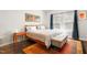 This bright bedroom is a cozy space with a bench at the end of the bed and a colorful area rug at 218 Archdale Dr, Durham, NC 27707