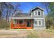 Charming home featuring a welcoming front porch with sturdy columns and new paint at 218 Archdale Dr, Durham, NC 27707