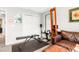 At home gym featuring multiple workout devices and a leather couch at 218 Archdale Dr, Durham, NC 27707
