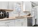 Bright kitchen featuring white cabinets, granite countertops, and stainless steel appliances at 218 Archdale Dr, Durham, NC 27707