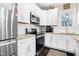 Well-equipped kitchen featuring white cabinets, stainless appliances, and granite countertops at 218 Archdale Dr, Durham, NC 27707