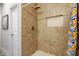 This shower features a tiled wall, recessed shelf, and banana print shower curtain at 218 Archdale Dr, Durham, NC 27707