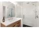 Modern bathroom featuring a glass enclosed shower with a wood vanity and neutral tiling at 222 Lions Gate Dr, Cary, NC 27518