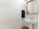 Neat powder room with pedestal sink, contemporary mirror, and sleek fixtures for a minimalist design at 222 Lions Gate Dr, Cary, NC 27518
