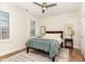 Bright bedroom featuring a ceiling fan, neutral walls, wood floors, and natural light from two windows at 222 Lions Gate Dr, Cary, NC 27518