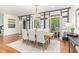 Elegant dining room featuring hardwood floors, chandelier, and access to an outdoor balcony at 222 Lions Gate Dr, Cary, NC 27518