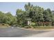 Community entrance sign with well-manicured landscaping and a decorative lion statue at 222 Lions Gate Dr, Cary, NC 27518