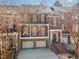 Charming three-story townhome with brick facade, attached garages, and front balcony at 222 Lions Gate Dr, Cary, NC 27518