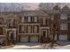 Charming three-story townhome with brick facade, attached garages, and front balcony at dusk at 222 Lions Gate Dr, Cary, NC 27518