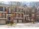 Charming three-story brick townhome with attached garages, and landscaped front entrance at 222 Lions Gate Dr, Cary, NC 27518