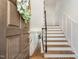 Bright foyer with hardwood floors, staircase, and decorative wreath on the front door at 222 Lions Gate Dr, Cary, NC 27518