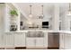 Modern kitchen featuring stainless steel appliances, custom cabinetry, and a breakfast bar at 222 Lions Gate Dr, Cary, NC 27518