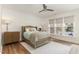 Serene main bedroom with panel molding, ceiling fan, natural light, and hardwood floors at 222 Lions Gate Dr, Cary, NC 27518
