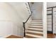 Elegant staircase featuring dark wood treads, white risers, and decorative wainscoting leading to upper level at 222 Lions Gate Dr, Cary, NC 27518