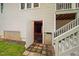 Exterior access to the basement with a paver walkway and white painted stairs at 227 Chimney Rise Dr, Cary, NC 27511