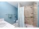 Neutral toned bathroom with shower and a turquoise accent wall at 227 Chimney Rise Dr, Cary, NC 27511