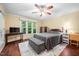 Inviting bedroom featuring hardwood floors, neutral walls, and a ceiling fan for added comfort at 227 Chimney Rise Dr, Cary, NC 27511