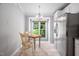 Bright dining area features tile floors, a round wood table, and a large window providing natural light at 227 Chimney Rise Dr, Cary, NC 27511