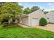 Charming home with a one-car garage, a well-maintained lawn, and mature landscaping at 227 Chimney Rise Dr, Cary, NC 27511