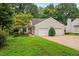 Charming home with a two-car garage, a well-maintained lawn, and mature landscaping at 227 Chimney Rise Dr, Cary, NC 27511