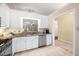 Charming kitchen featuring granite countertops, white cabinets, and a view into the living area at 227 Chimney Rise Dr, Cary, NC 27511