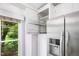 Modern kitchen cabinet featuring pull-out shelves for organized storage and convenience with backyard view at 227 Chimney Rise Dr, Cary, NC 27511