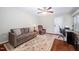 Comfortable living room with hardwood floors, a sofa, recliner, and a ceiling fan at 227 Chimney Rise Dr, Cary, NC 27511