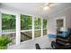 Relaxing screened-in porch with comfortable seating and a view of the wooded backyard at 227 Chimney Rise Dr, Cary, NC 27511